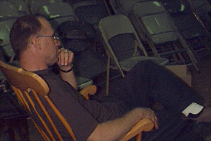 drama teacher watching students perform